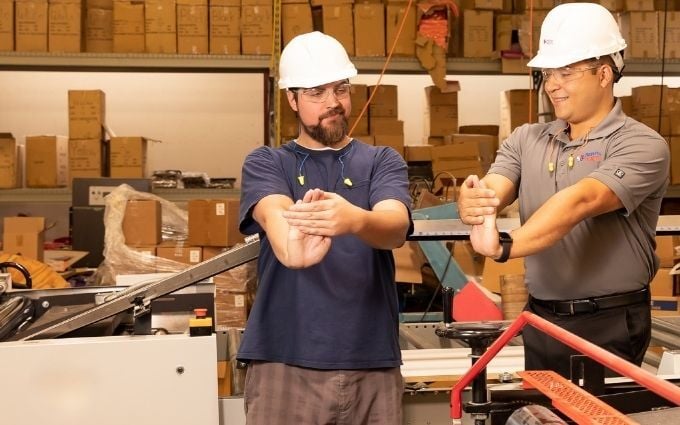 Industrial Athletic Trainer works with a manufacturing employee to reduce fatigue