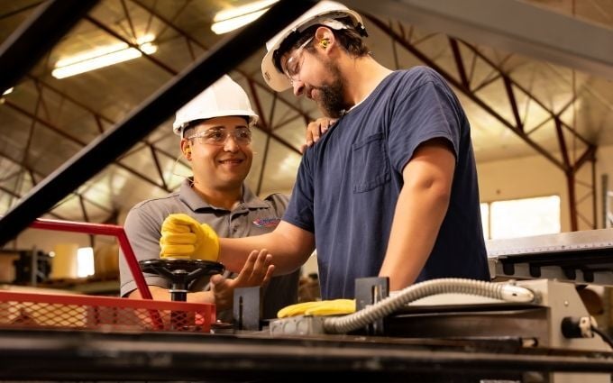 Industrial Sports Medicine Professional gives body mechanics coaching to manufacturing employee