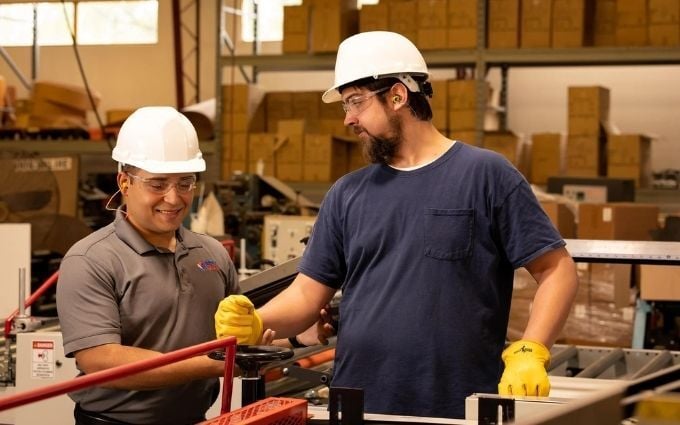 Industrial athletic trainer works with employee on job site