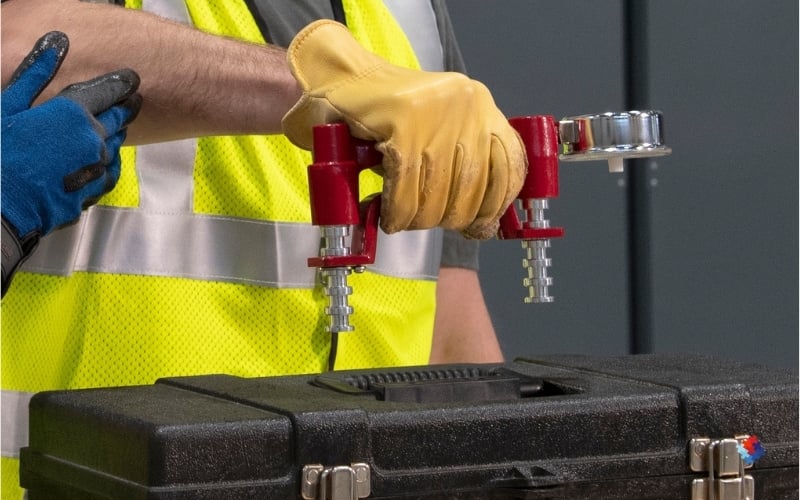 Demonstration of a specialized tool being use to measure the grip strength needed to lift a toolbox. 