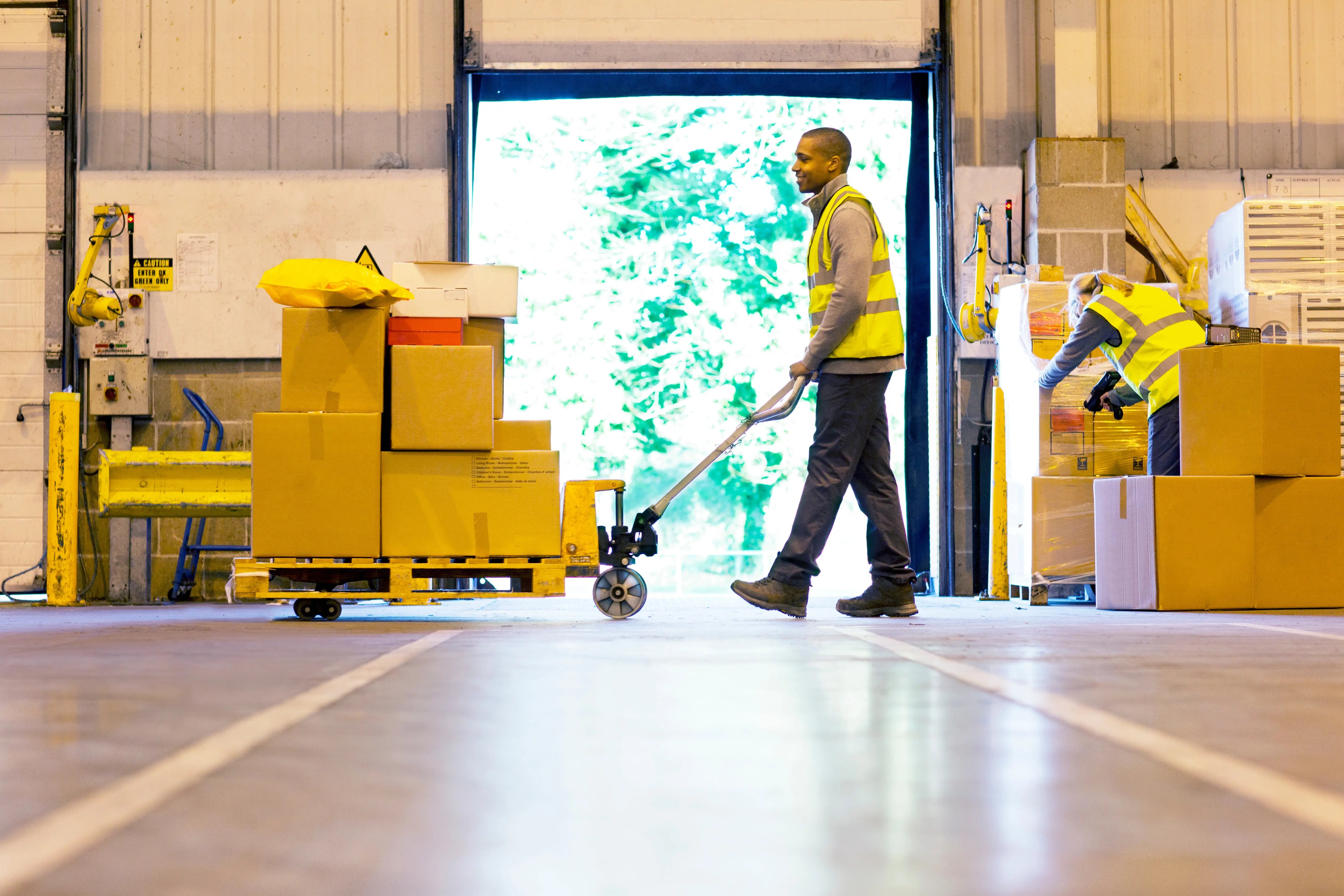 Man moves boxes with pallet jack