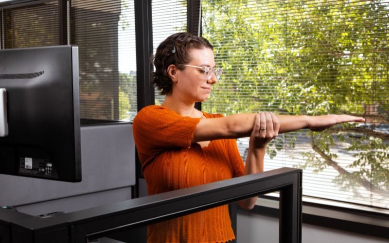 Office worker stretching at their desk