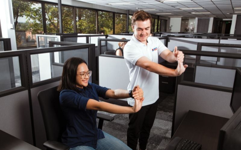 Office workers stretching at their desk