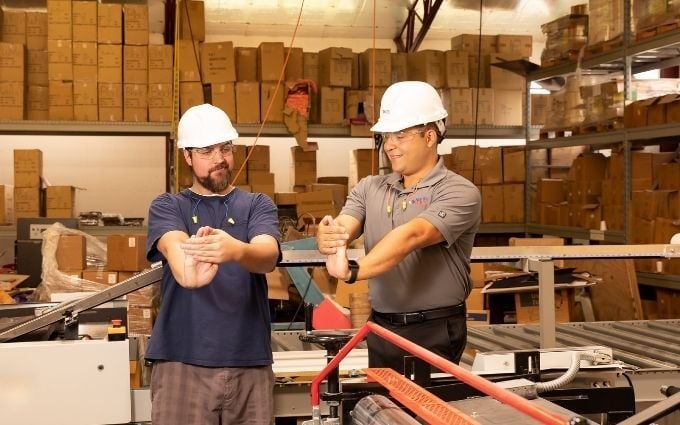 Onsite ISM Provider works with employee demonstrating counterbalance stretching