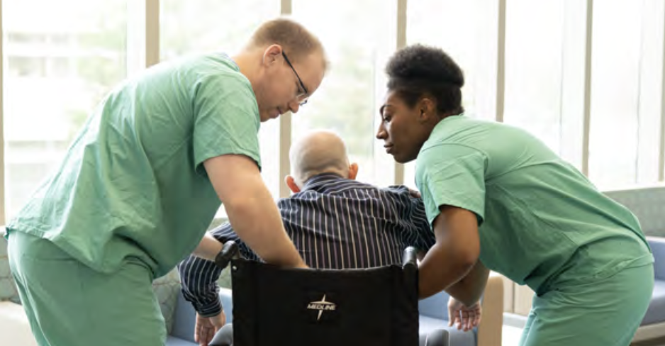 healthcare workers assisting a patient