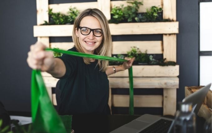 Woman using exercise band at her desk