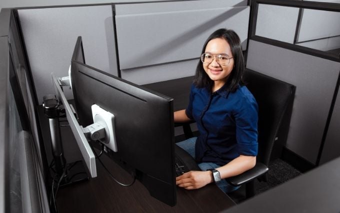 Woman working at cubicle desk with neutral posture