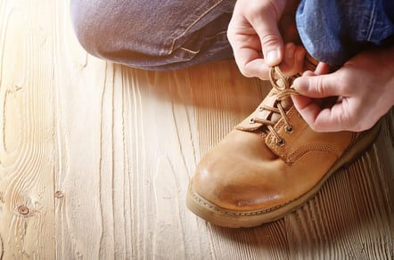 bigstock-Carpenter-In-Blue-Jeans-Tying--246249002