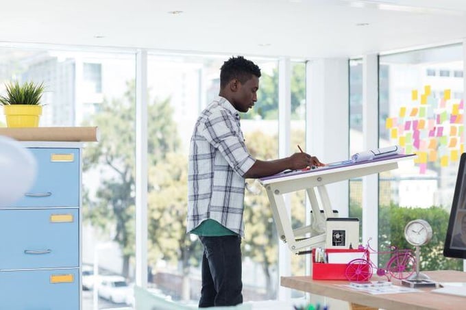 employee utilizing a standing desk