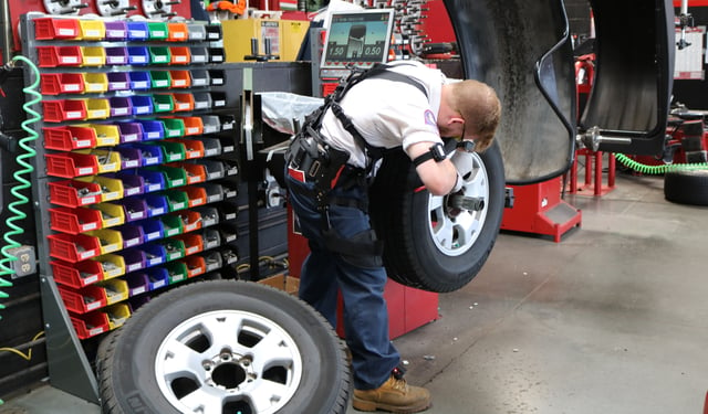 Worker wearing exoskeleton